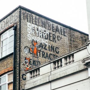 get rich or try sharing ghost sign street art